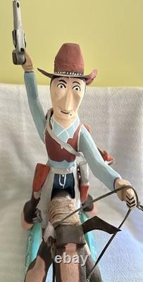 Cowboy folklorique unique, sculpté et façonné à la main, sur cheval à bascule en bois