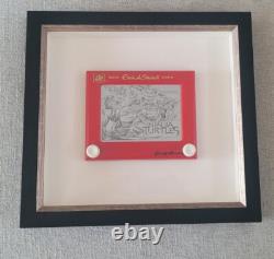 Une œuvre unique : croquis/dessin/boîte à ombres authentiquement signée sur un Etch-A-Sketch