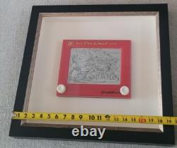 Une œuvre unique : croquis/dessin/boîte à ombres authentiquement signée sur un Etch-A-Sketch